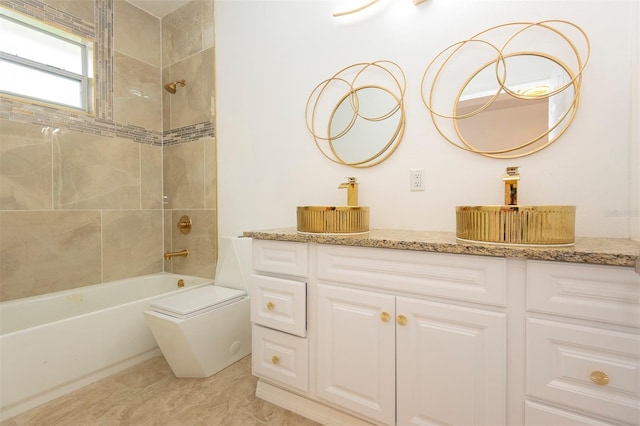 bathroom featuring toilet, tub / shower combination, and vanity