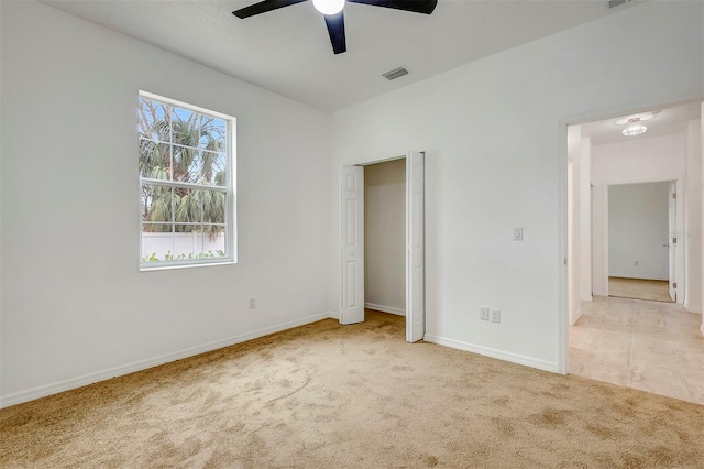 unfurnished bedroom featuring a ceiling fan, baseboards, visible vents, and carpet flooring