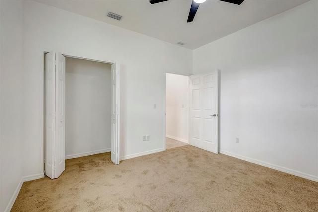 unfurnished bedroom featuring carpet floors, baseboards, visible vents, and a ceiling fan