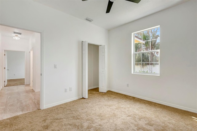 unfurnished bedroom featuring carpet, visible vents, and baseboards