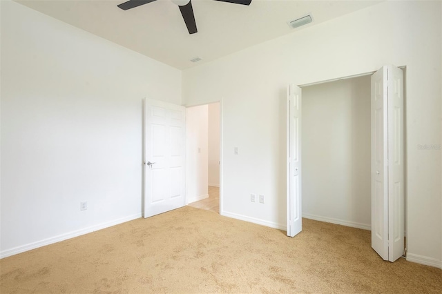 unfurnished bedroom with ceiling fan, carpet flooring, visible vents, and baseboards