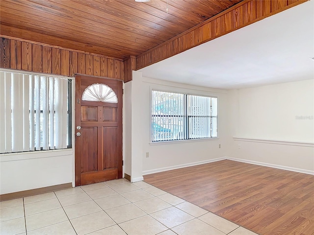 entrance foyer featuring wood ceiling, baseboards, and light tile patterned floors