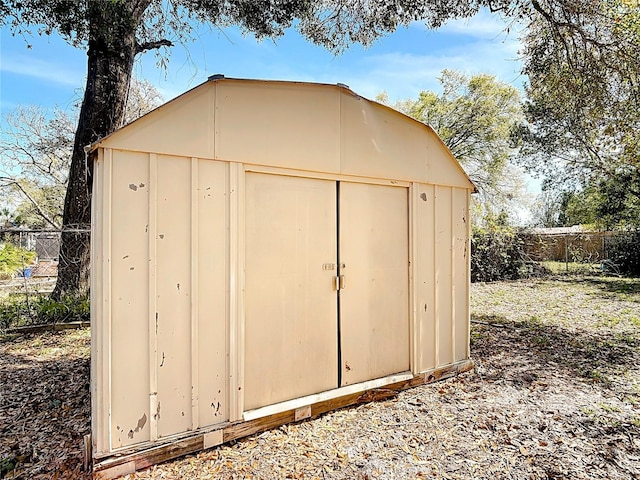 view of shed with fence