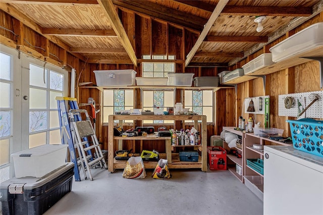 interior space featuring finished concrete flooring and wooden walls