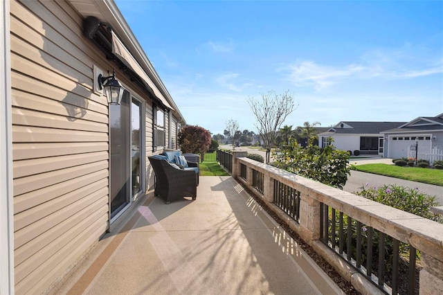 view of patio / terrace featuring a balcony and a residential view