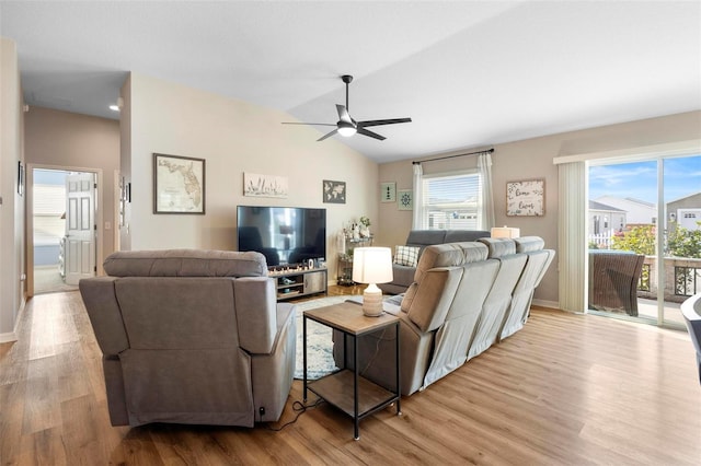 living area featuring ceiling fan, baseboards, vaulted ceiling, and wood finished floors