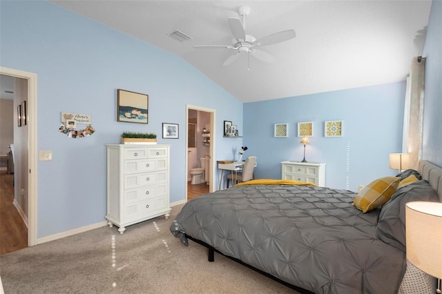 bedroom with lofted ceiling, a ceiling fan, visible vents, baseboards, and ensuite bath