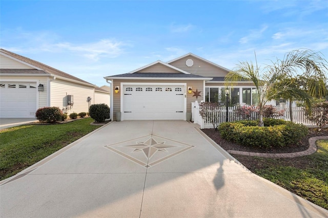 ranch-style house featuring a garage, driveway, and fence