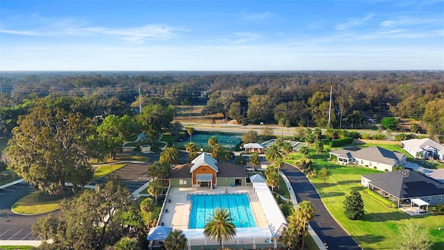 birds eye view of property featuring a view of trees