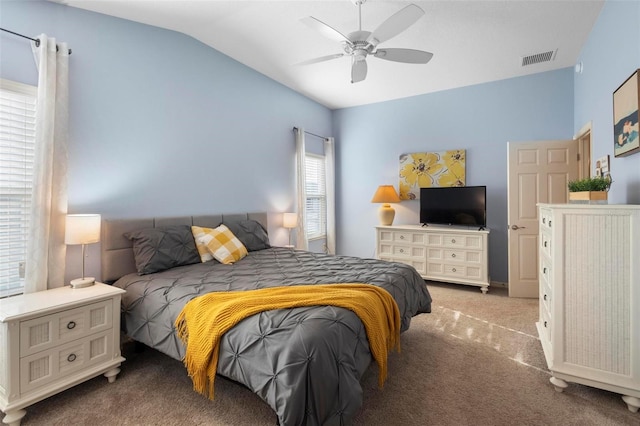 bedroom featuring ceiling fan, visible vents, vaulted ceiling, and carpet flooring