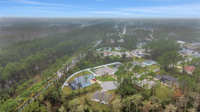 birds eye view of property with a residential view and a view of trees