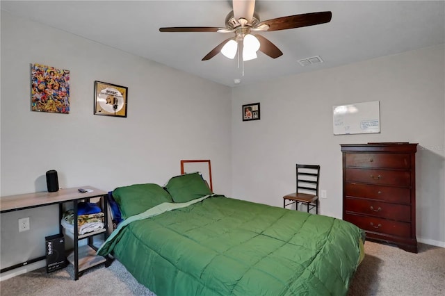 carpeted bedroom featuring ceiling fan and visible vents