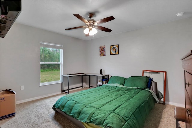 carpeted bedroom featuring a ceiling fan and baseboards