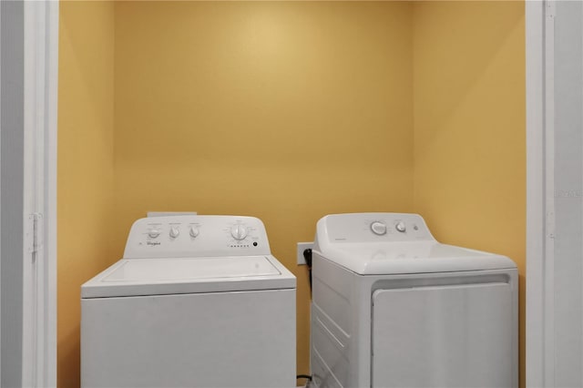 laundry room with laundry area and washing machine and clothes dryer