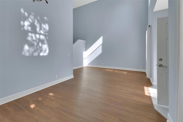 unfurnished living room featuring baseboards and wood finished floors