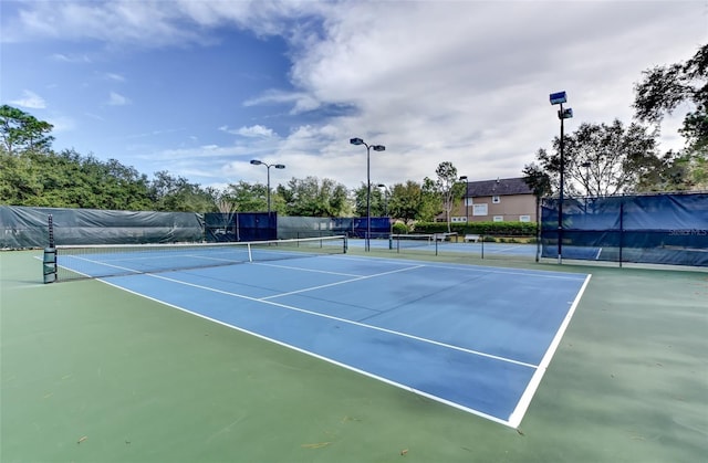 view of sport court with fence