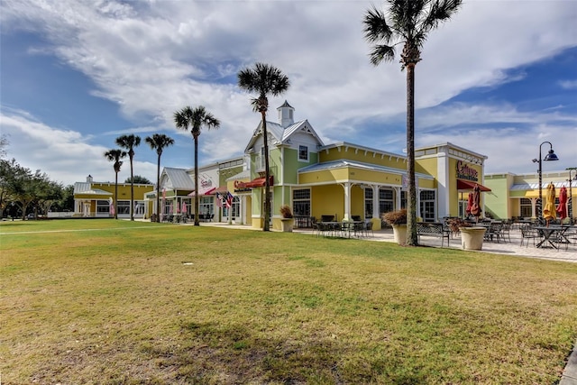 view of home's community featuring a lawn