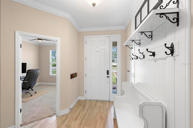 mudroom with light wood finished floors, ornamental molding, and baseboards