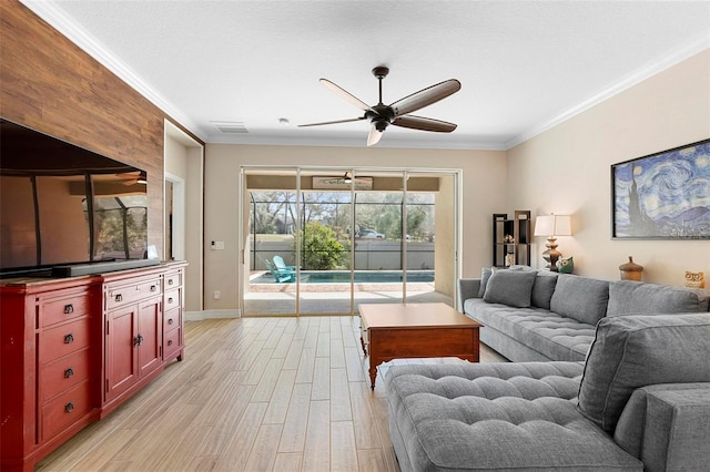 living room with visible vents, a sunroom, ceiling fan, crown molding, and light wood-style floors