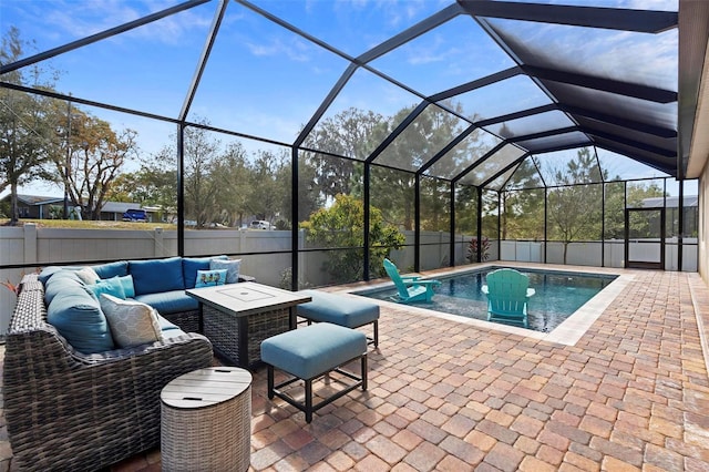 view of pool featuring glass enclosure, outdoor lounge area, a fenced in pool, and a patio