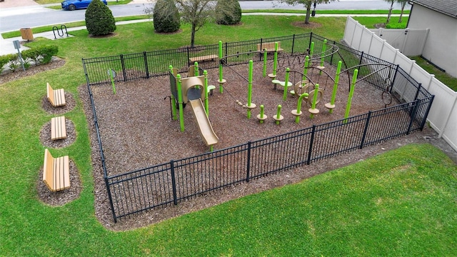 surrounding community with a garden, a yard, and fence