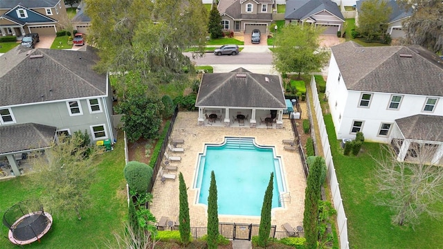 pool featuring a patio area, a fenced backyard, and a residential view