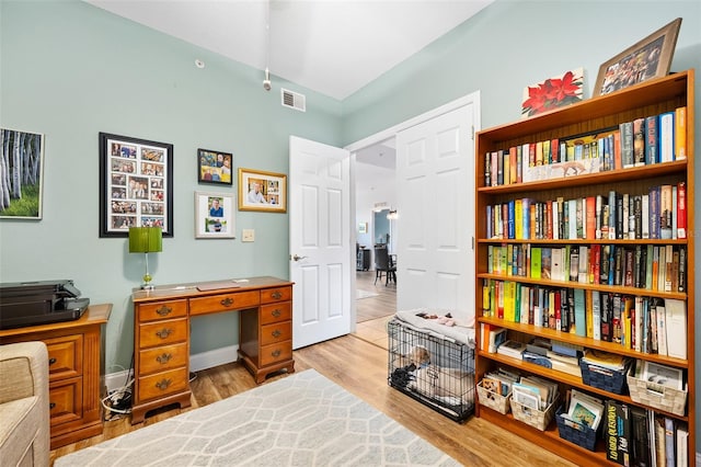 home office with visible vents and wood finished floors