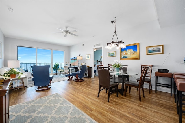 dining space featuring ceiling fan, baseboards, and wood finished floors