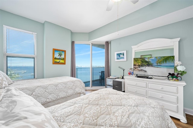 bedroom with access to outside, ceiling fan, and wood finished floors