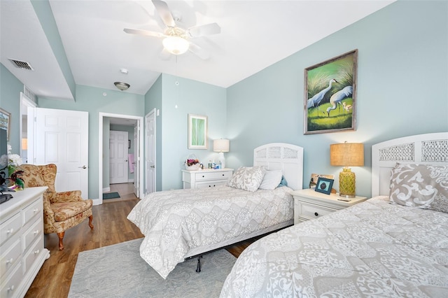 bedroom with a ceiling fan, visible vents, and dark wood-style flooring