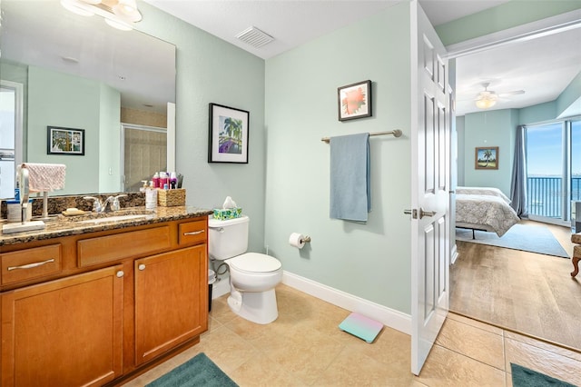 bathroom featuring toilet, vanity, visible vents, a stall shower, and ensuite bath