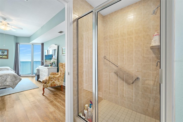 full bath featuring ensuite bathroom, wood finished floors, visible vents, a ceiling fan, and a shower stall