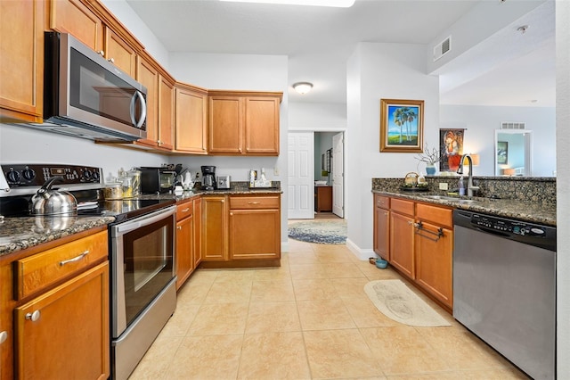 kitchen with light tile patterned floors, visible vents, appliances with stainless steel finishes, and a sink