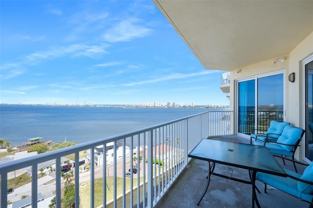 balcony with a water view and a view of city