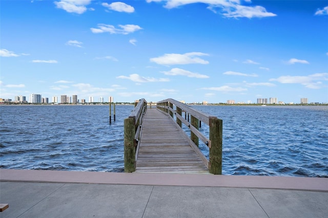 view of dock with a view of city and a water view