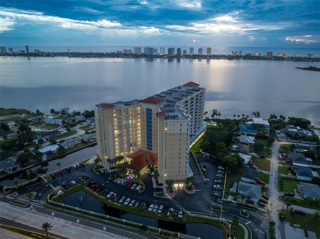 drone / aerial view featuring a city view and a water view