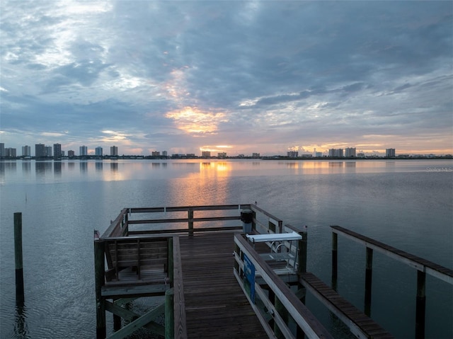 dock area featuring a city view and a water view