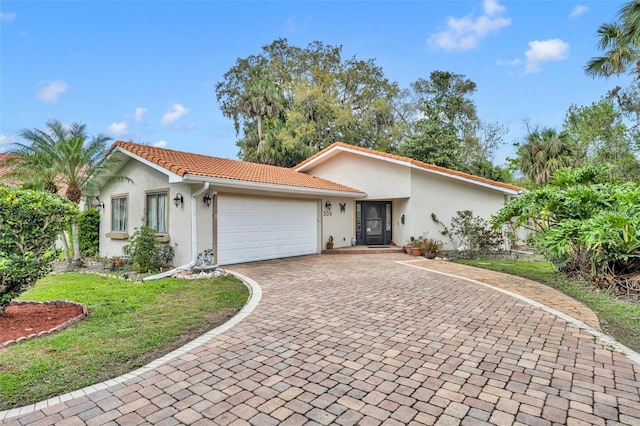 view of front of home featuring a tile roof, decorative driveway, a garage, and stucco siding