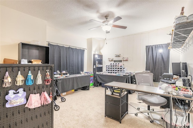 carpeted office space with a ceiling fan and a textured ceiling