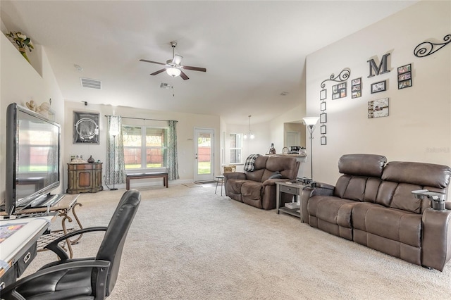 carpeted living room featuring ceiling fan, lofted ceiling, and visible vents