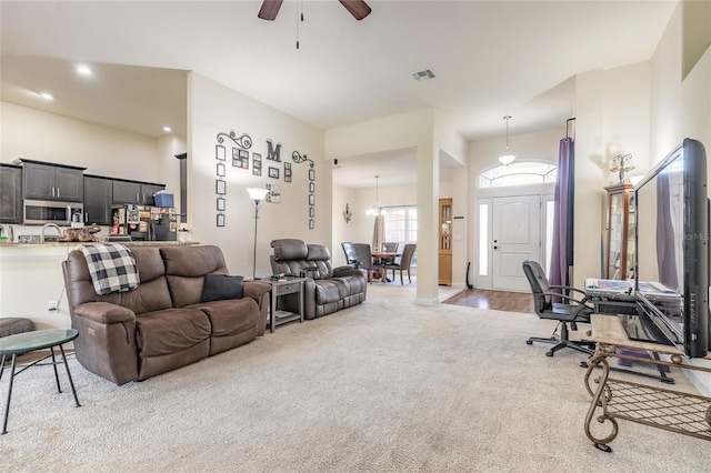 living area with a ceiling fan, recessed lighting, light carpet, and visible vents