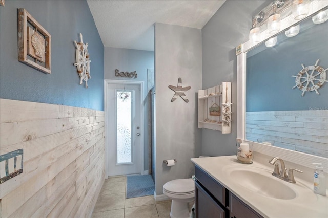 full bathroom featuring tile patterned flooring, toilet, vanity, walk in shower, and mail area