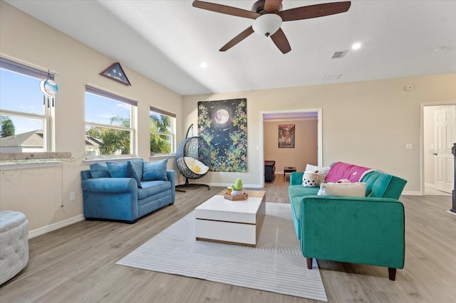 living area featuring wood finished floors, visible vents, and baseboards