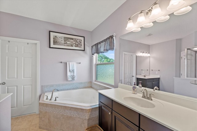 bathroom featuring two vanities, tile patterned flooring, a sink, and a bath