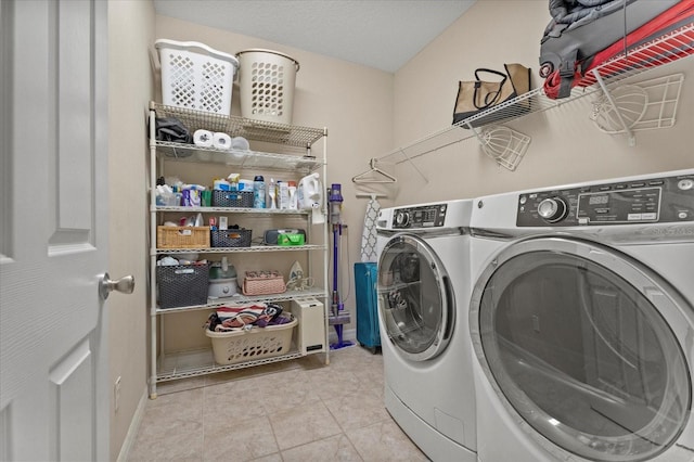 laundry room featuring laundry area, tile patterned flooring, baseboards, and separate washer and dryer