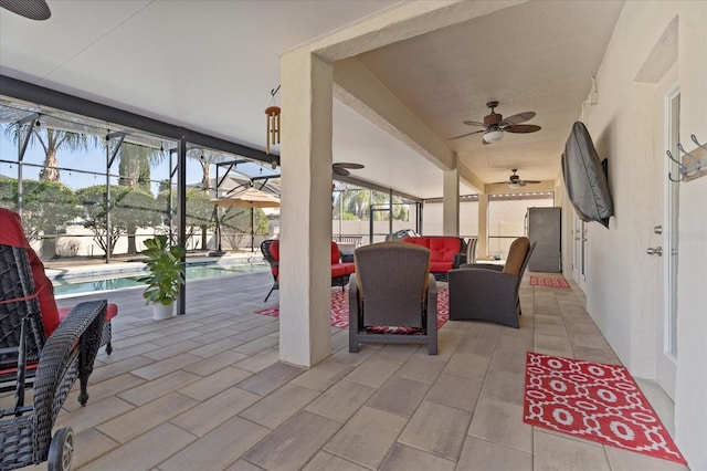 view of patio with an outdoor pool, a lanai, and ceiling fan