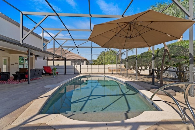 view of pool with glass enclosure, a fenced in pool, a ceiling fan, and a patio