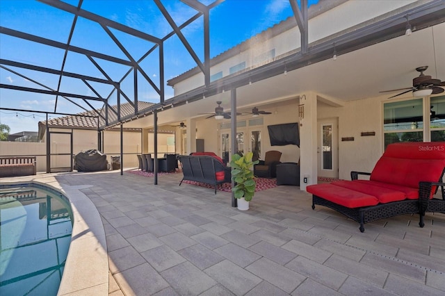 view of patio with a fenced in pool, a lanai, ceiling fan, and an outdoor living space