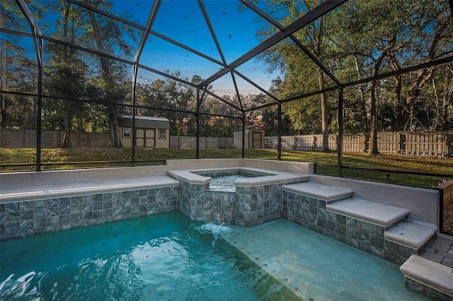 view of pool with glass enclosure, a fenced backyard, an outdoor structure, and a storage shed