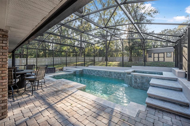 view of swimming pool featuring a fenced backyard, a shed, a patio, and an outbuilding